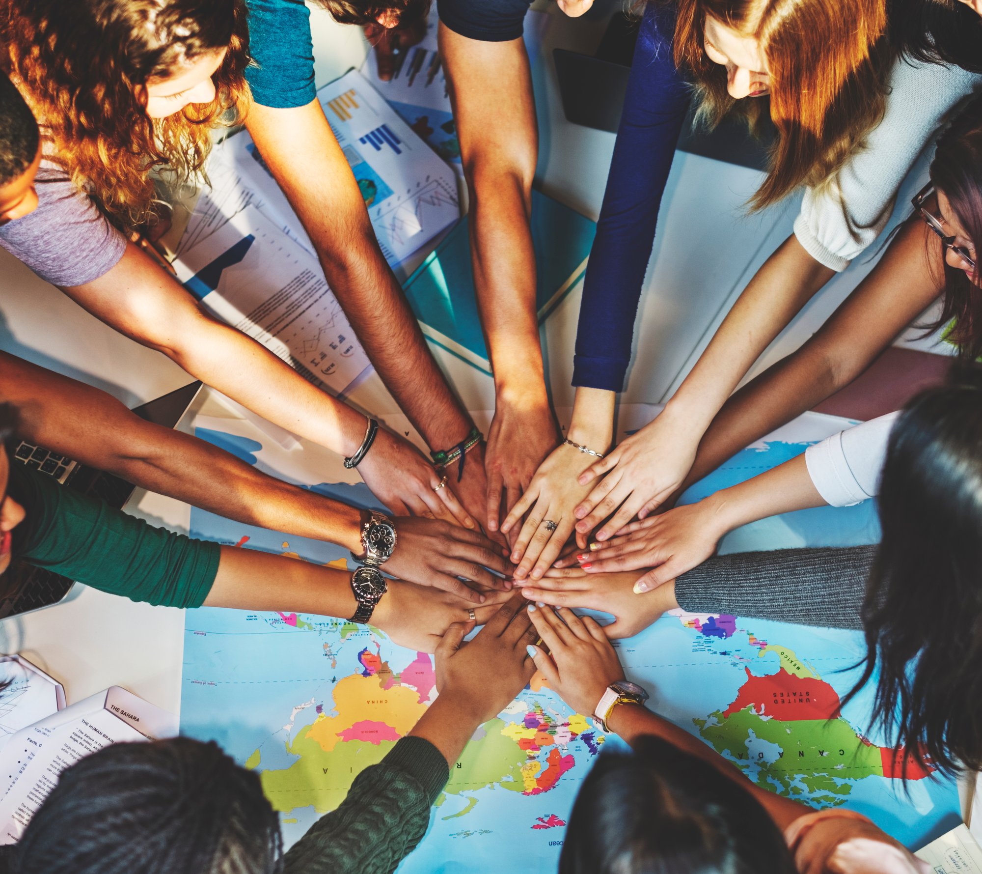 diverse-team-joining-hands-over-world-map-2026-01-07-23-43-49-utc diverse-team-joining-hands-over-world-map-2026-01-07-23-43-49-utc