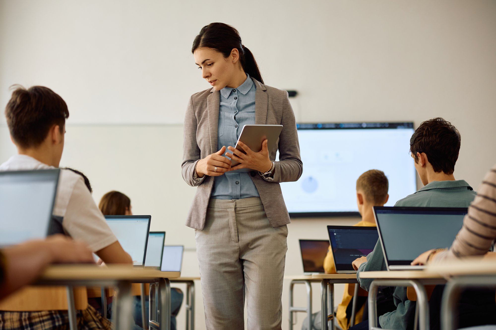 female-teacher-assisting-students-with-learning-co-2026-01-06-10-27-33-utc female-teacher-assisting-students-with-learning-co-2026-01-06-10-27-33-utc