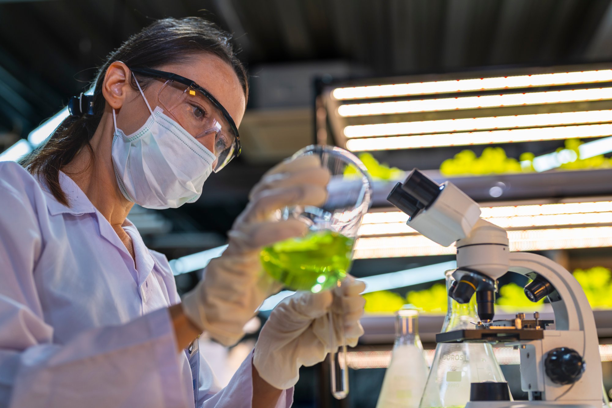 a-scientist-wearing-a-mask-and-gloves-works-in-a-l-2025-04-14-09-40-53-utc a-scientist-wearing-a-mask-and-gloves-works-in-a-l-2025-04-14-09-40-53-utc