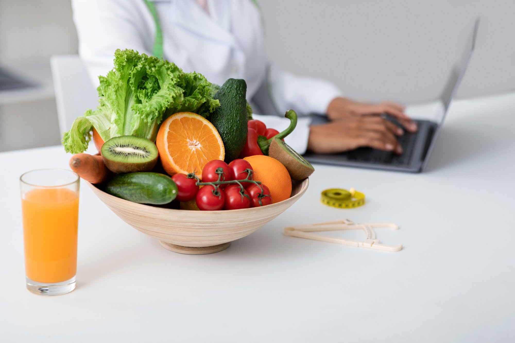 side-view-of-nutritionist-working-with-laptop-at-c-2023-11-27-05-20-22-utc side-view-of-nutritionist-working-with-laptop-at-c-2023-11-27-05-20-22-utc